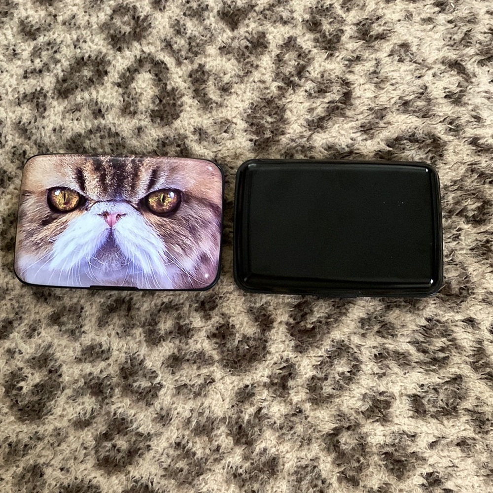 One black aluma wallet and one generic cat wallet (both are hard cases)